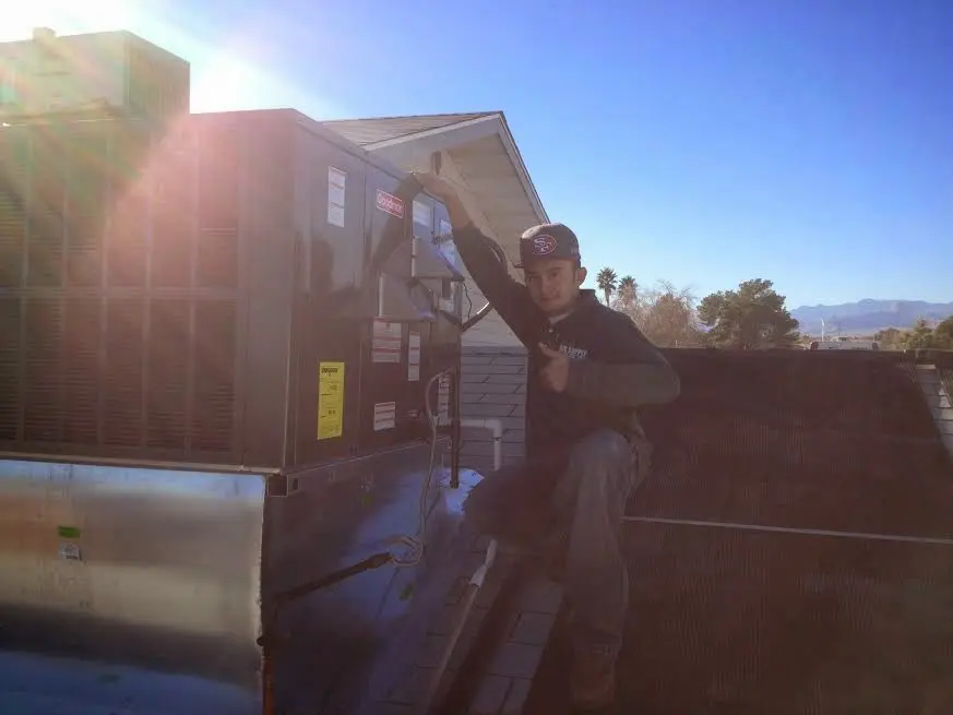 HVAC technician performing HVAC Inspection on a rooftop unit in Kentfield